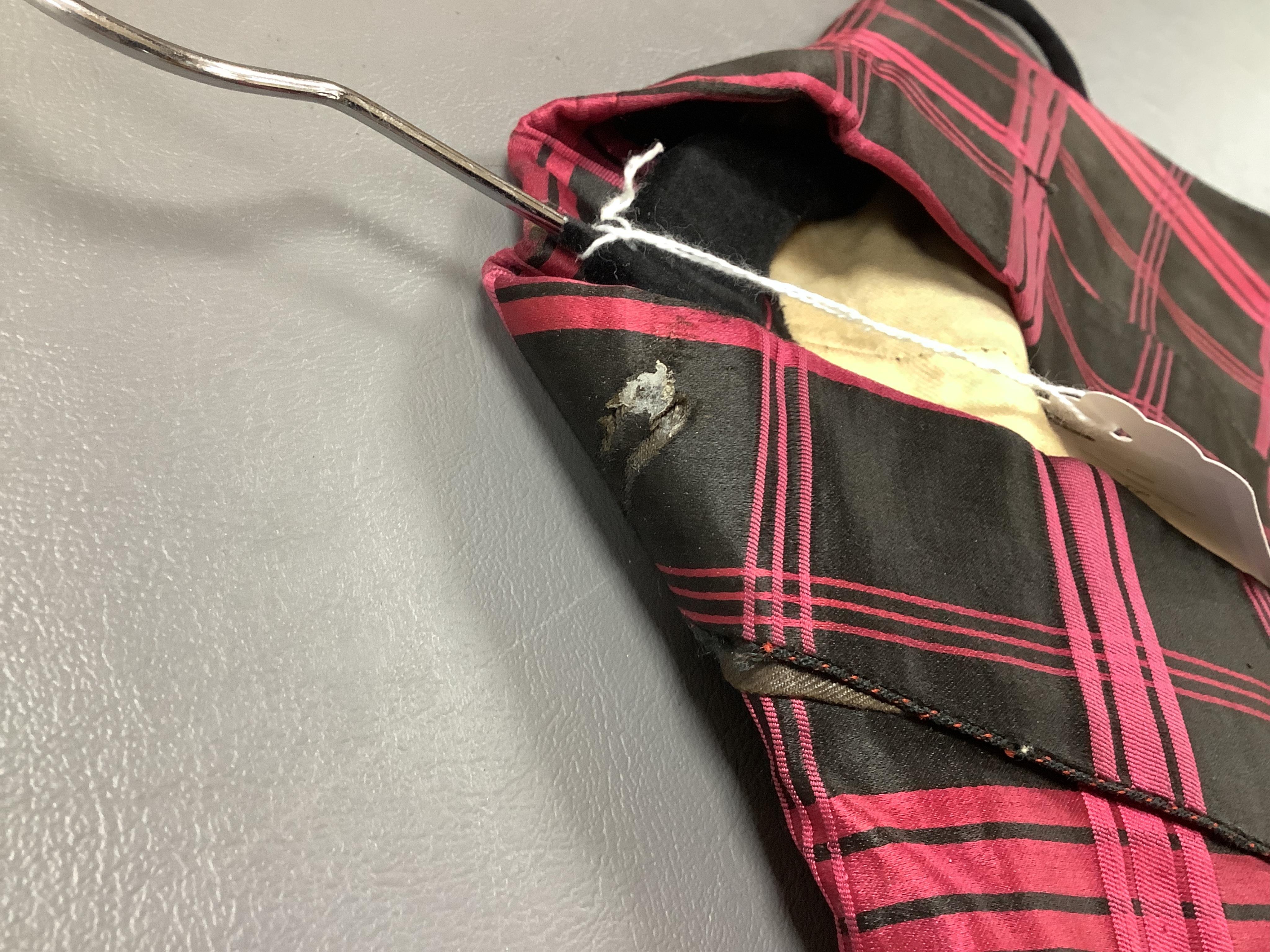 A 19th century gentleman's pink and black silk check waistcoat, with collar and two pockets. Front under arm chest 50cm. Condition - lining stained may need professional cleaning.